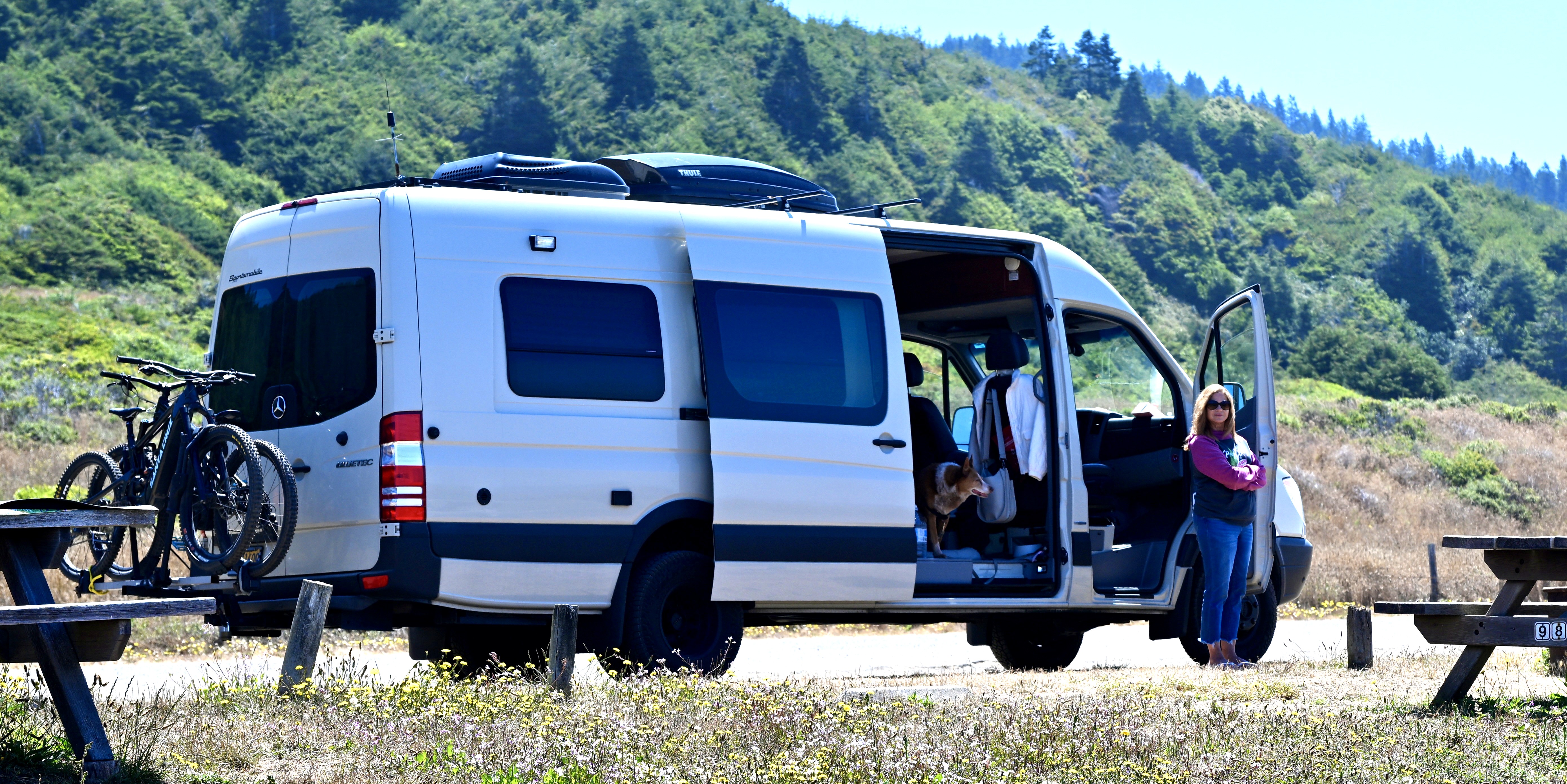 The author's own Sportsmobile, a white 2013 Sprinter 170 EXT, at a coastal campsite